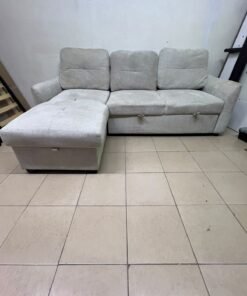 # Convertible Fabric Corner Sofa Bed with Chaise Longue and Storage – Home Box UAE Upgrade your living room with this practical and stylish convertible fabric corner sofa bed from Home Box UAE, designed to combine comfort, functionality, and modern elegance in one versatile piece of furniture. Featuring a spacious three-seater design with an extended chaise longue, this sofa provides plenty of room for relaxing, watching television, entertaining guests, or spending quality time with family. Its attractive fabric upholstery adds a warm and welcoming touch to any living space, making it an excellent choice for apartments, villas, guest rooms, and modern homes. One of the main advantages of this corner sofa is its convertible sofa-bed function, which allows you to transform the seating area into a comfortable sleeping space whenever needed. This practical feature makes it especially suitable for homes where extra sleeping arrangements are occasionally required without sacrificing valuable floor space. Whether you have overnight visitors or simply want a comfortable place to stretch out and relax, this multifunctional design offers flexibility for everyday living. The extended chaise longue provides additional legroom, allowing you to sit back comfortably, read a book, enjoy your favourite shows, or take a relaxing afternoon nap. The spacious seating arrangement makes it suitable for individuals, couples, and families looking for furniture that offers both convenience and comfort. Another useful feature is the integrated storage compartment, which provides extra room for keeping blankets, pillows, bedsheets, cushions, and other household essentials neatly organised and within easy reach. With its combination of seating, sleeping, and storage functions, this fabric corner sofa is an excellent space-saving solution for contemporary interiors. Its versatile design allows it to serve as the main sofa in a living room while also functioning as a guest bed and a convenient storage unit. The fabric finish complements a variety of interior styles, including modern, minimalist, contemporary, and casual home décor, making it easy to incorporate into different living environments. If you are searching for an affordable and functional sofa bed in Dubai, Sharjah, or Ajman, this Home Box-style convertible corner sofa is worth considering for its practical features and versatile use. It is particularly suitable for people furnishing a new apartment, upgrading their existing living room, or looking for multifunctional furniture that makes the most of available space. At Yahya Used Furniture, we offer a wide selection of second-hand furniture for customers looking for practical home furnishing solutions at affordable prices. If you are interested in buying a used corner sofa, sofa bed, chaise longue, or other living room furniture, explore our available collection to discover options that suit your space and budget. Choose a sofa that brings together comfortable seating, flexible sleeping arrangements, and useful storage in one convenient design. This convertible fabric corner sofa bed is a practical furniture choice for making your living room more comfortable, organised, and ready for everyday life. - Image 9