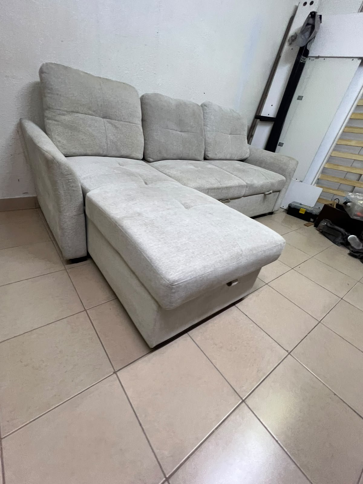 # Convertible Fabric Corner Sofa Bed with Chaise Longue and Storage – Home Box UAE Upgrade your living room with this practical and stylish convertible fabric corner sofa bed from Home Box UAE, designed to combine comfort, functionality, and modern elegance in one versatile piece of furniture. Featuring a spacious three-seater design with an extended chaise longue, this sofa provides plenty of room for relaxing, watching television, entertaining guests, or spending quality time with family. Its attractive fabric upholstery adds a warm and welcoming touch to any living space, making it an excellent choice for apartments, villas, guest rooms, and modern homes. One of the main advantages of this corner sofa is its convertible sofa-bed function, which allows you to transform the seating area into a comfortable sleeping space whenever needed. This practical feature makes it especially suitable for homes where extra sleeping arrangements are occasionally required without sacrificing valuable floor space. Whether you have overnight visitors or simply want a comfortable place to stretch out and relax, this multifunctional design offers flexibility for everyday living. The extended chaise longue provides additional legroom, allowing you to sit back comfortably, read a book, enjoy your favourite shows, or take a relaxing afternoon nap. The spacious seating arrangement makes it suitable for individuals, couples, and families looking for furniture that offers both convenience and comfort. Another useful feature is the integrated storage compartment, which provides extra room for keeping blankets, pillows, bedsheets, cushions, and other household essentials neatly organised and within easy reach. With its combination of seating, sleeping, and storage functions, this fabric corner sofa is an excellent space-saving solution for contemporary interiors. Its versatile design allows it to serve as the main sofa in a living room while also functioning as a guest bed and a convenient storage unit. The fabric finish complements a variety of interior styles, including modern, minimalist, contemporary, and casual home décor, making it easy to incorporate into different living environments. If you are searching for an affordable and functional sofa bed in Dubai, Sharjah, or Ajman, this Home Box-style convertible corner sofa is worth considering for its practical features and versatile use. It is particularly suitable for people furnishing a new apartment, upgrading their existing living room, or looking for multifunctional furniture that makes the most of available space. At Yahya Used Furniture, we offer a wide selection of second-hand furniture for customers looking for practical home furnishing solutions at affordable prices. If you are interested in buying a used corner sofa, sofa bed, chaise longue, or other living room furniture, explore our available collection to discover options that suit your space and budget. Choose a sofa that brings together comfortable seating, flexible sleeping arrangements, and useful storage in one convenient design. This convertible fabric corner sofa bed is a practical furniture choice for making your living room more comfortable, organised, and ready for everyday life. - Image 12