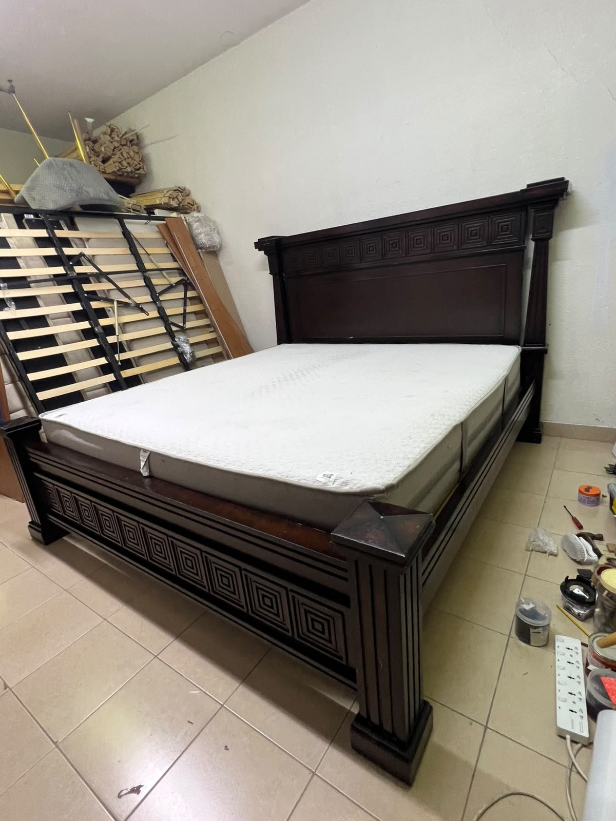 Large, classic double bed (king-size) with mattress, crafted from dark wood and featuring a headboard and footboard adorned with square-patterned detailing. - Image 2