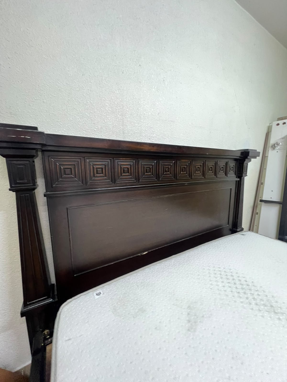 Large, classic double bed (king-size) with mattress, crafted from dark wood and featuring a headboard and footboard adorned with square-patterned detailing. - Image 5