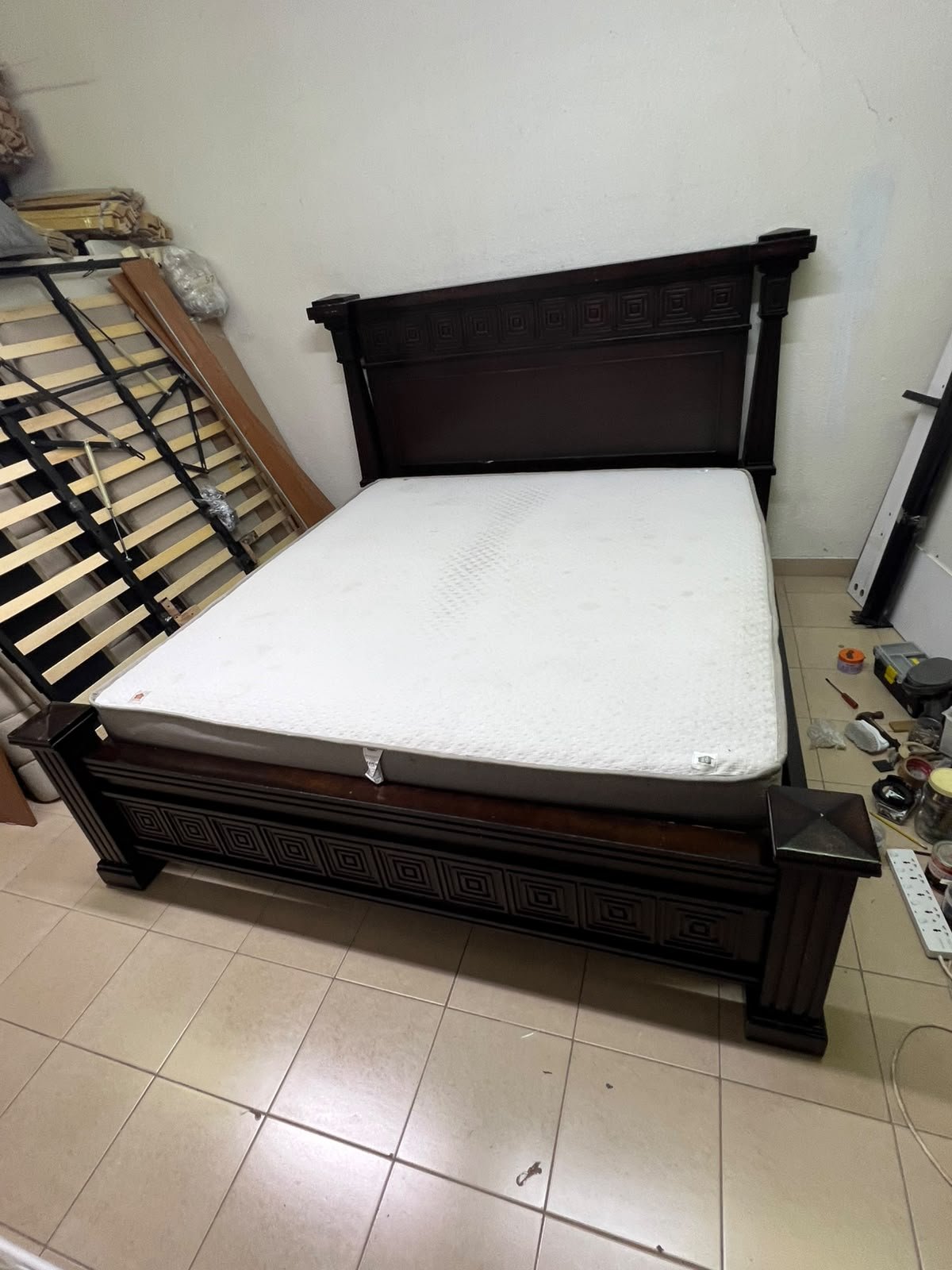 Large, classic double bed (king-size) with mattress, crafted from dark wood and featuring a headboard and footboard adorned with square-patterned detailing. - Image 8