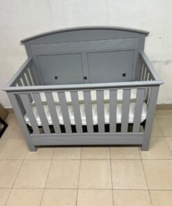 A convertible crib (such as the Serta Barrett model or the Dylan crib by Juniors, available at Centrepoint UAE) in an elegant gray color, featuring a classic, adjustable design that adapts to the various stages of a child's growth. - Image 9