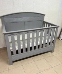 A convertible crib (such as the Serta Barrett model or the Dylan crib by Juniors, available at Centrepoint UAE) in an elegant gray color, featuring a classic, adjustable design that adapts to the various stages of a child's growth. - Image 10