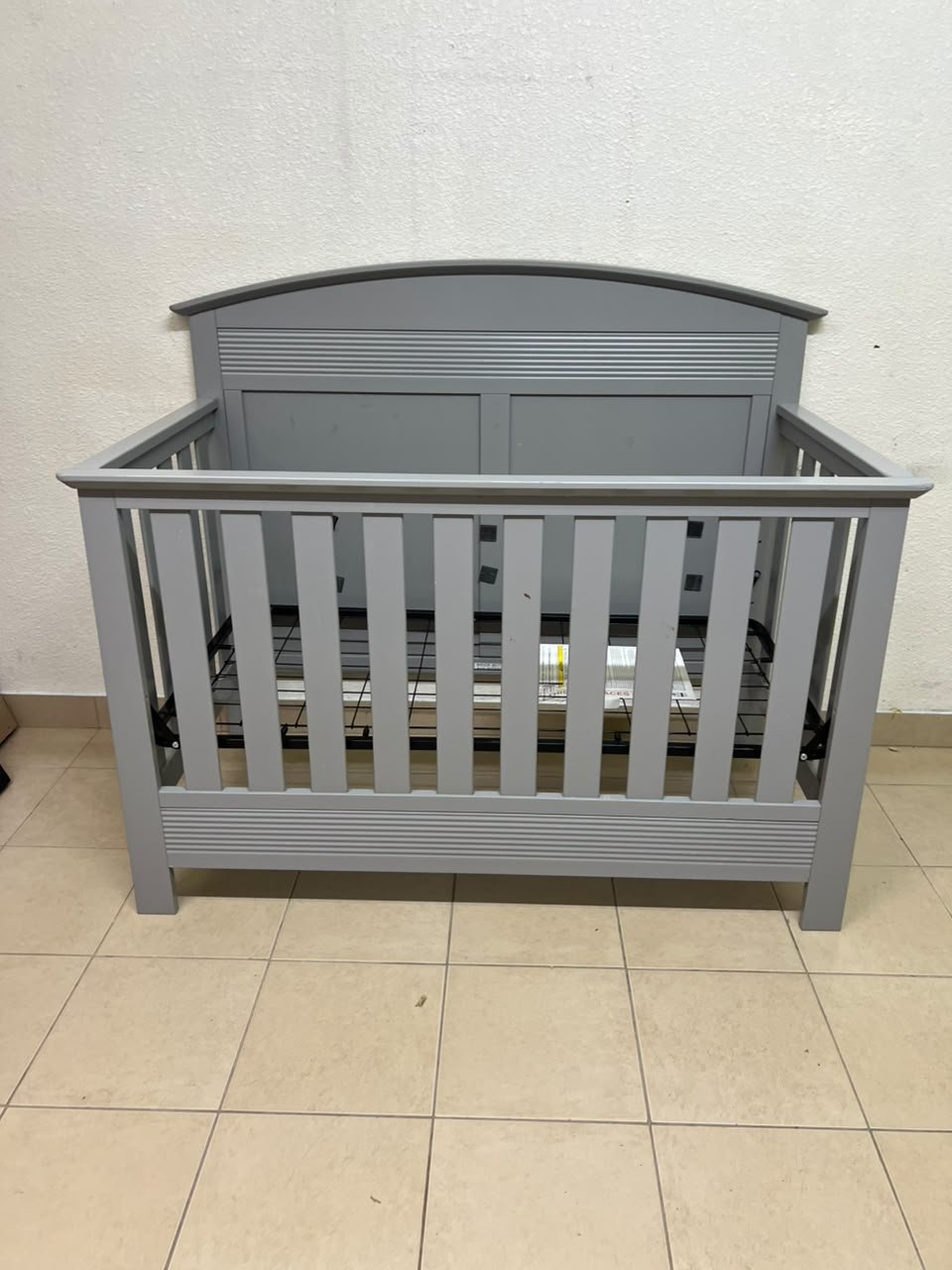 A convertible crib (such as the Serta Barrett model or the Dylan crib by Juniors, available at Centrepoint UAE) in an elegant gray color, featuring a classic, adjustable design that adapts to the various stages of a child's growth. - Image 11