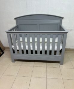 A convertible crib (such as the Serta Barrett model or the Dylan crib by Juniors, available at Centrepoint UAE) in an elegant gray color, featuring a classic, adjustable design that adapts to the various stages of a child's growth. - Image 2