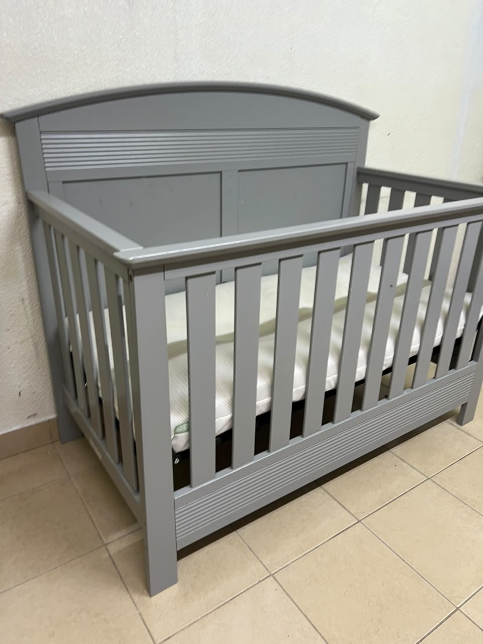 A convertible crib (such as the Serta Barrett model or the Dylan crib by Juniors, available at Centrepoint UAE) in an elegant gray color, featuring a classic, adjustable design that adapts to the various stages of a child's growth. - Image 3