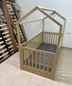 A wooden Montessori house bed—a floor-level or low-profile bed featuring side guardrails—designed to ensure safety while fostering the child's freedom of movement and independence. - Image 2