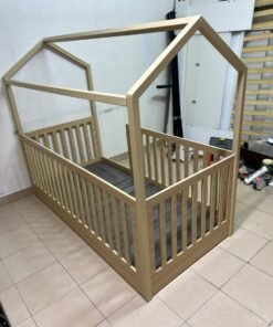 A wooden Montessori house bed—a floor-level or low-profile bed featuring side guardrails—designed to ensure safety while fostering the child's freedom of movement and independence. - Image 3