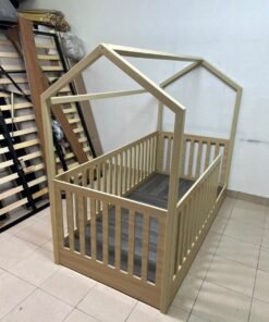 A wooden Montessori house bed—a floor-level or low-profile bed featuring side guardrails—designed to ensure safety while fostering the child's freedom of movement and independence. - Image 5