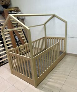 A wooden Montessori house bed—a floor-level or low-profile bed featuring side guardrails—designed to ensure safety while fostering the child's freedom of movement and independence.