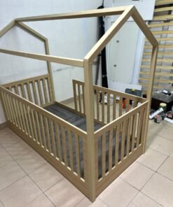 A wooden Montessori house bed—a floor-level or low-profile bed featuring side guardrails—designed to ensure safety while fostering the child's freedom of movement and independence. - Image 7