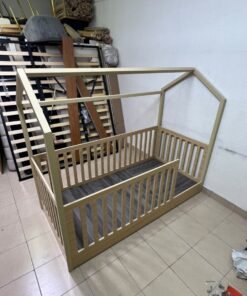 A wooden Montessori house bed—a floor-level or low-profile bed featuring side guardrails—designed to ensure safety while fostering the child's freedom of movement and independence. - Image 8