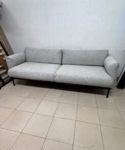A modern-design sofa—resembling the ÄPPLARYD model from IKEA—upholstered in light gray (Lejde light gray) and featuring elevated black metal legs.