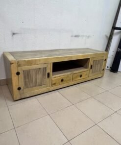 The TV stand shown in the image—a "Band TV" unit—is crafted from natural wood and features an industrial-style design. It includes two side doors, an open shelf in the center, and two small drawers at the bottom. - Image 2