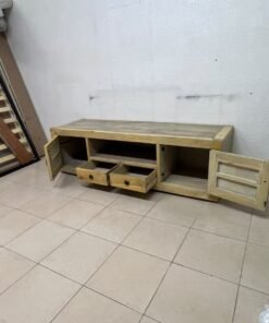 The TV stand shown in the image—a "Band TV" unit—is crafted from natural wood and features an industrial-style design. It includes two side doors, an open shelf in the center, and two small drawers at the bottom. - Image 5