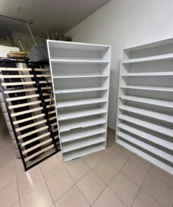 Three white open shelving/display units, constructed from wood, melamine, or MDF, featuring multi-level shelves. - Image 5