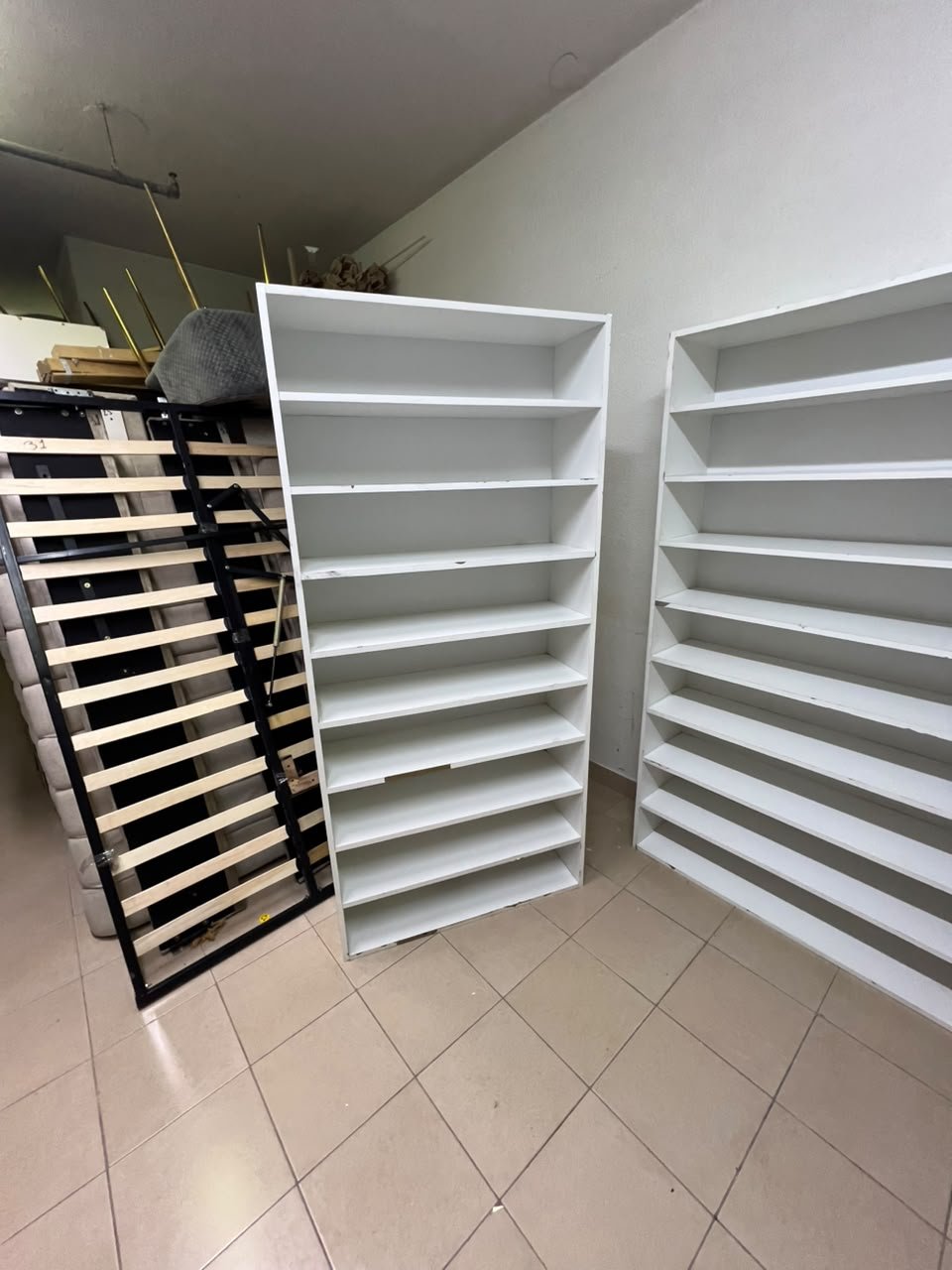 Three white open shelving/display units, constructed from wood, melamine, or MDF, featuring multi-level shelves. - Image 5