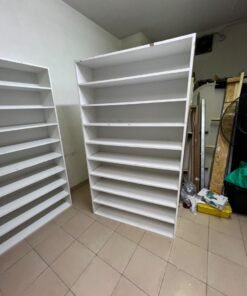 Three white open shelving/display units, constructed from wood, melamine, or MDF, featuring multi-level shelves. - Image 7