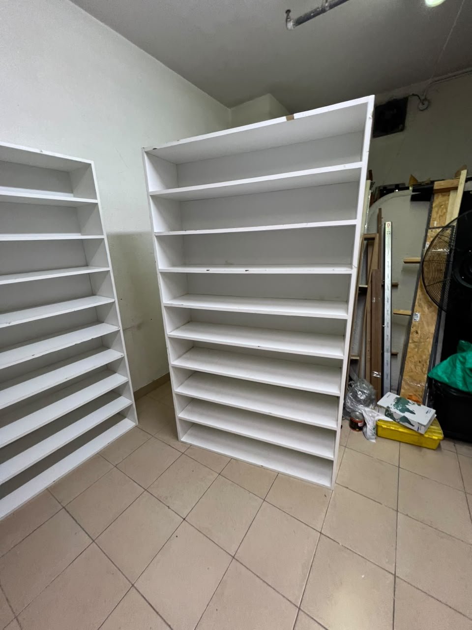 Three white open shelving/display units, constructed from wood, melamine, or MDF, featuring multi-level shelves. - Image 7