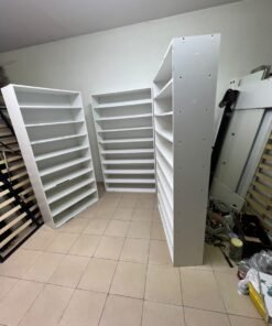 Three white open shelving/display units, constructed from wood, melamine, or MDF, featuring multi-level shelves. - Image 8