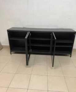 A cabinet (such as a TV stand or sideboard) that appears as a glossy black storage unit with three doors and slender legs; it bears a strong resemblance to the IKEA BESTÅ collection (specifically the Selsviken/Stubbarp combination in black-brown with high-gloss doors). - Image 10