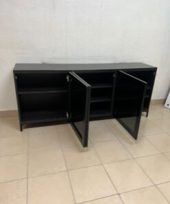 A cabinet (such as a TV stand or sideboard) that appears as a glossy black storage unit with three doors and slender legs; it bears a strong resemblance to the IKEA BESTÅ collection (specifically the Selsviken/Stubbarp combination in black-brown with high-gloss doors). - Image 12