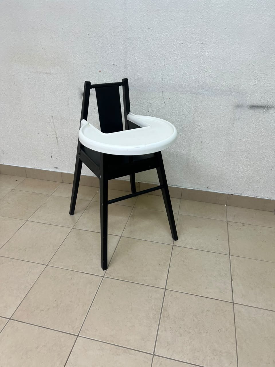 IKEA BLÅMES high chair for children, in black with a white tray.