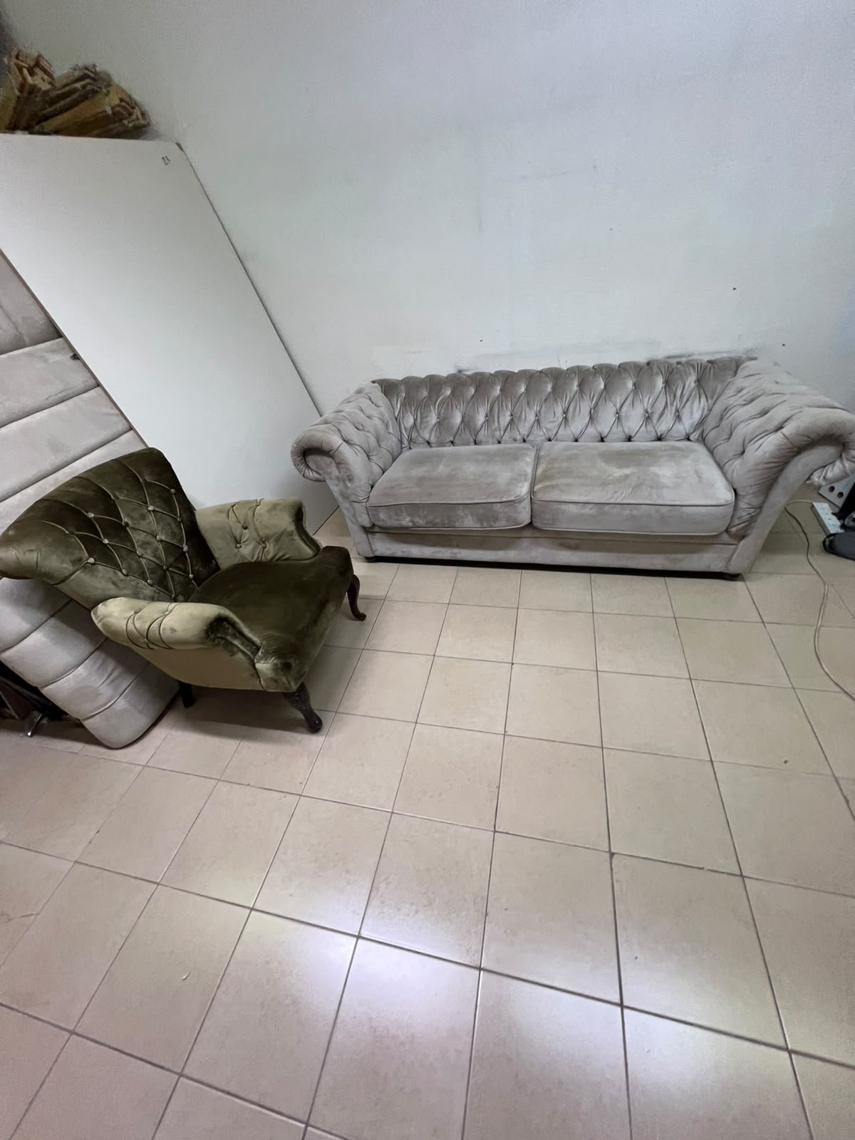 Classic Chesterfield-style furniture upholstered in velvet, featuring a long grey or silver sofa with a button-tufted backrest, accompanied by a matching armchair (fauteuil) in a dark green or olive shade, sharing the same plush, classic design. - Image 2