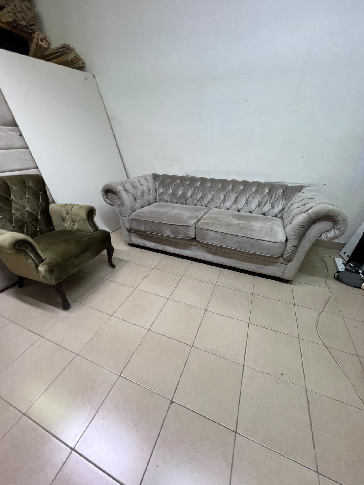 Classic Chesterfield-style furniture upholstered in velvet, featuring a long grey or silver sofa with a button-tufted backrest, accompanied by a matching armchair (fauteuil) in a dark green or olive shade, sharing the same plush, classic design. - Image 4