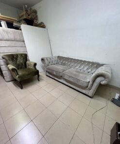 Classic Chesterfield-style furniture upholstered in velvet, featuring a long grey or silver sofa with a button-tufted backrest, accompanied by a matching armchair (fauteuil) in a dark green or olive shade, sharing the same plush, classic design. - Image 8