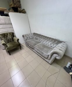 Classic Chesterfield-style furniture upholstered in velvet, featuring a long grey or silver sofa with a button-tufted backrest, accompanied by a matching armchair (fauteuil) in a dark green or olive shade, sharing the same plush, classic design. - Image 12