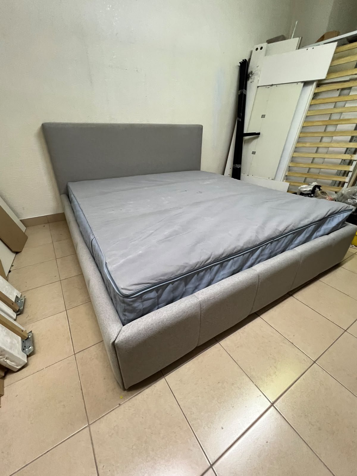 Light gray upholstered bed featuring a high headboard with a vertical channel-tufted design; part of a collection of platform storage beds. - Image 9