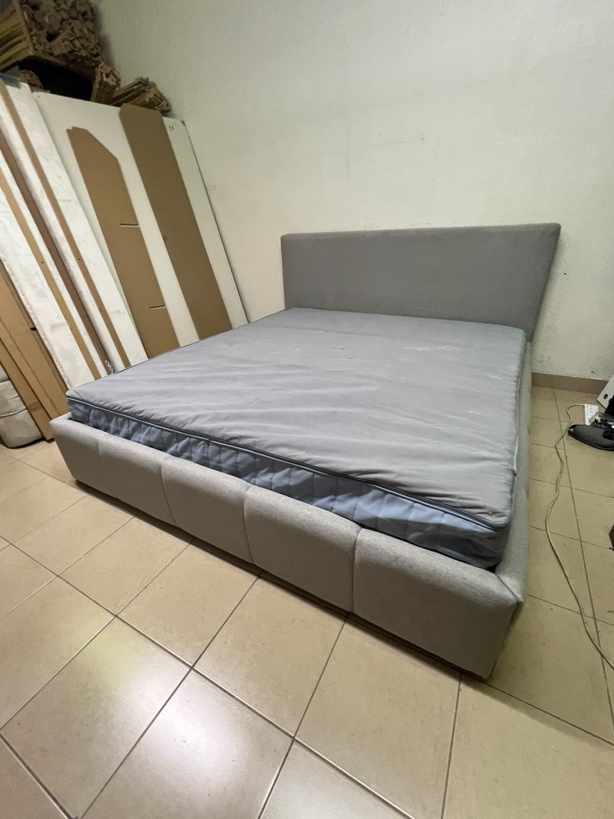 Light gray upholstered bed featuring a high headboard with a vertical channel-tufted design; part of a collection of platform storage beds. - Image 10