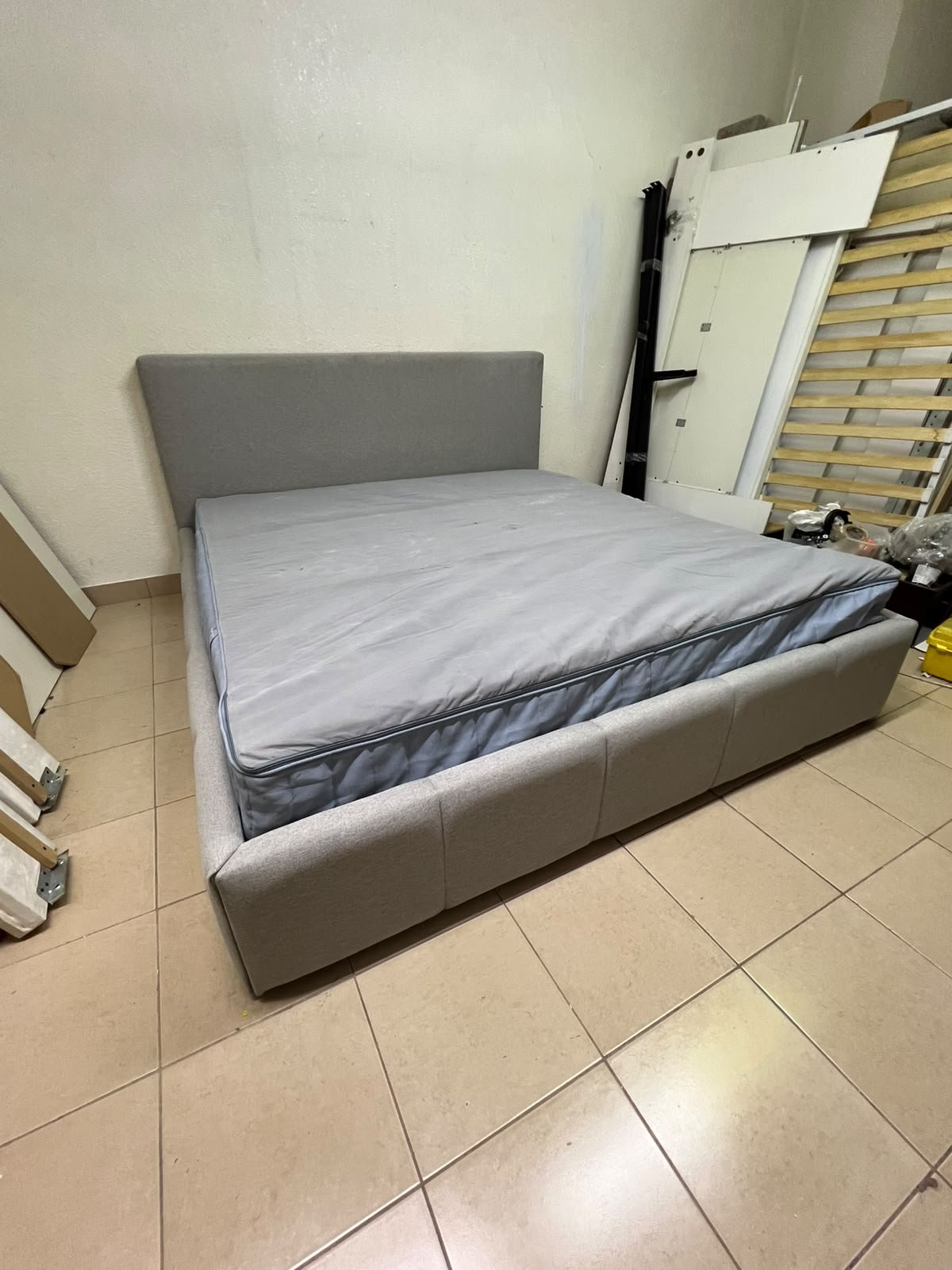 Light gray upholstered bed featuring a high headboard with a vertical channel-tufted design; part of a collection of platform storage beds. - Image 11