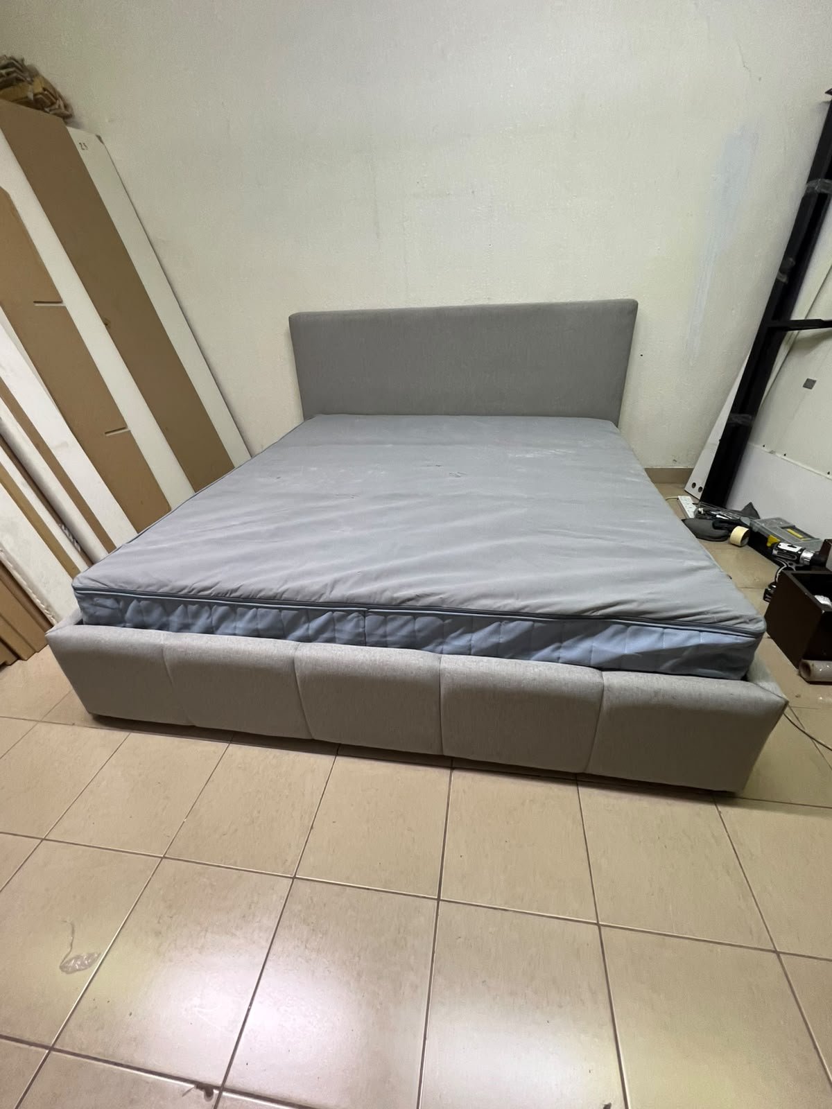 Light gray upholstered bed featuring a high headboard with a vertical channel-tufted design; part of a collection of platform storage beds. - Image 2