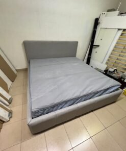 Light gray upholstered bed featuring a high headboard with a vertical channel-tufted design; part of a collection of platform storage beds. - Image 3