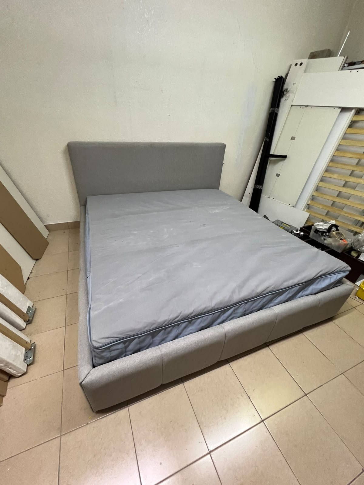 Light gray upholstered bed featuring a high headboard with a vertical channel-tufted design; part of a collection of platform storage beds. - Image 3