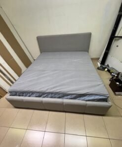 Light gray upholstered bed featuring a high headboard with a vertical channel-tufted design; part of a collection of platform storage beds. - Image 4