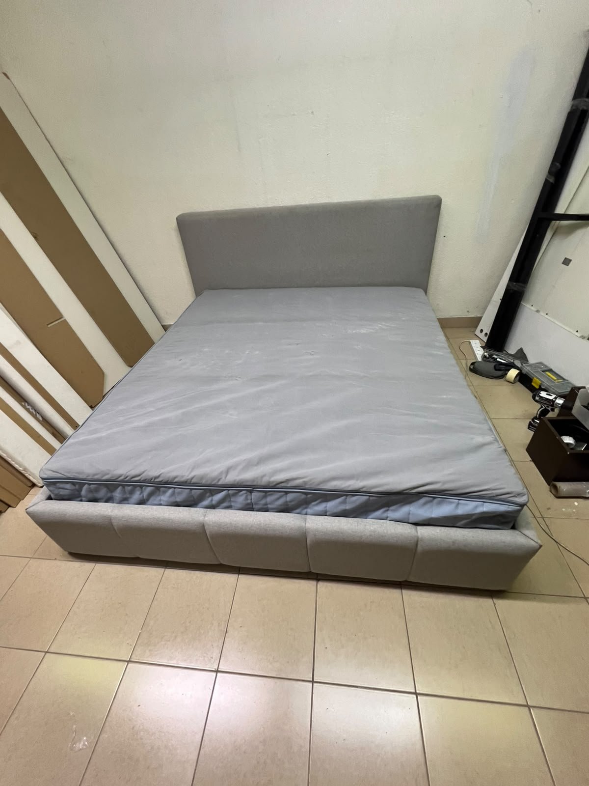 Light gray upholstered bed featuring a high headboard with a vertical channel-tufted design; part of a collection of platform storage beds. - Image 4