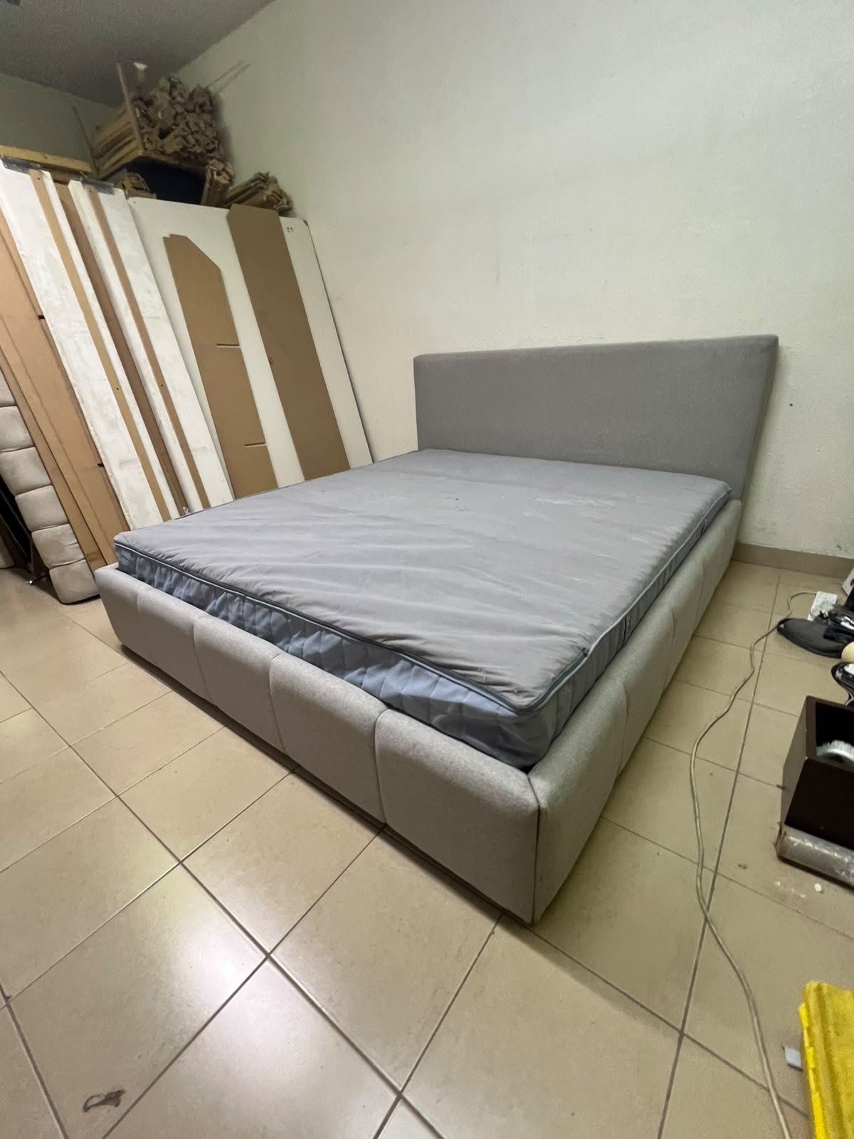 Light gray upholstered bed featuring a high headboard with a vertical channel-tufted design; part of a collection of platform storage beds. - Image 5
