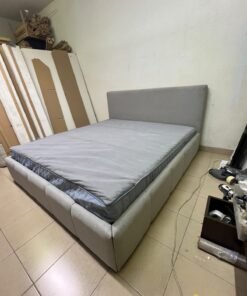 Light gray upholstered bed featuring a high headboard with a vertical channel-tufted design; part of a collection of platform storage beds.