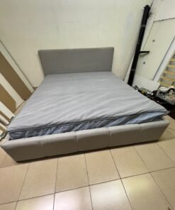Light gray upholstered bed featuring a high headboard with a vertical channel-tufted design; part of a collection of platform storage beds. - Image 7