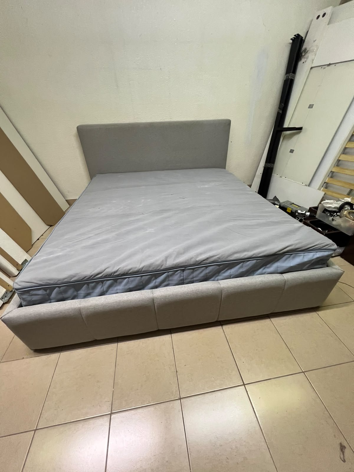 Light gray upholstered bed featuring a high headboard with a vertical channel-tufted design; part of a collection of platform storage beds. - Image 7