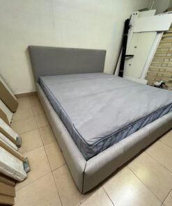 Light gray upholstered bed featuring a high headboard with a vertical channel-tufted design; part of a collection of platform storage beds. - Image 8
