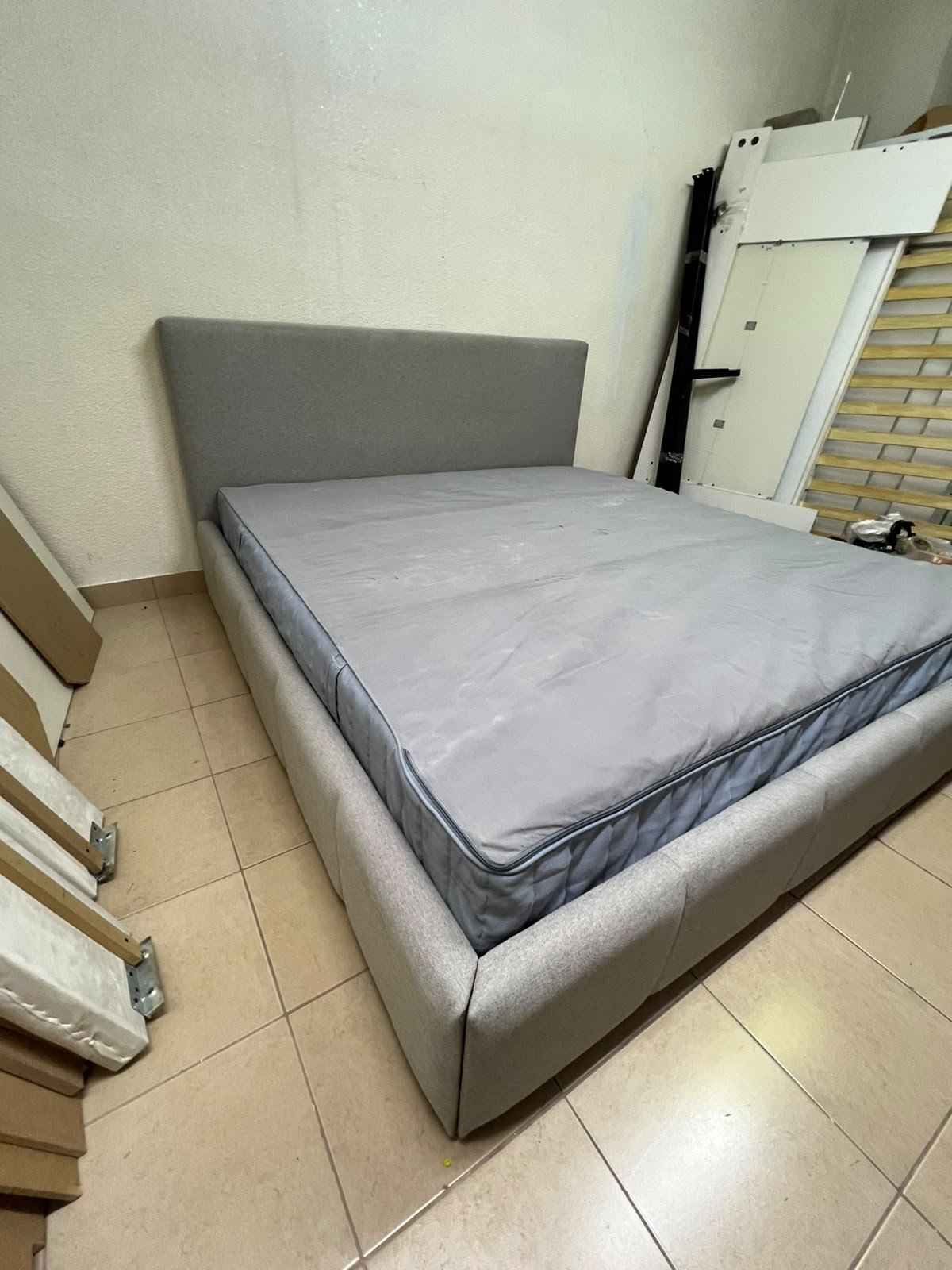 Light gray upholstered bed featuring a high headboard with a vertical channel-tufted design; part of a collection of platform storage beds. - Image 8