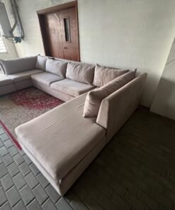 A U-shaped sectional sofa upholstered in beige or light gray fabric, featuring separate backrest cushions and two chaise longue/footrest sections on the sides. - Image 6