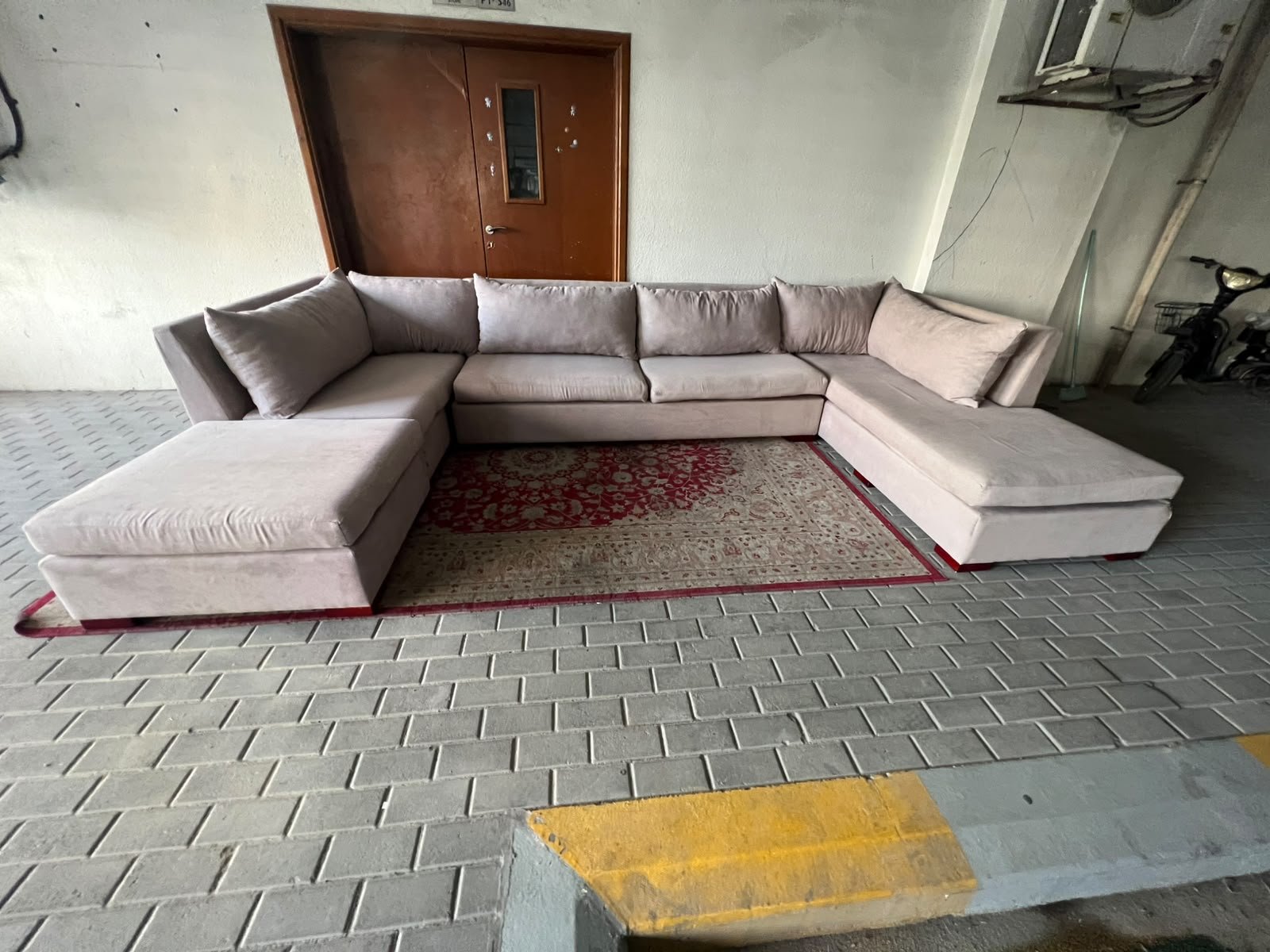 A U-shaped sectional sofa upholstered in beige or light gray fabric, featuring separate backrest cushions and two chaise longue/footrest sections on the sides. - Image 8