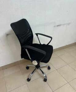 A black office chair featuring a comfortable mesh back, a chrome metal base with casters, armrests, and adjustable height. - Image 6