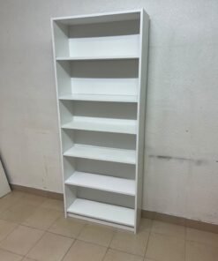 A white bookcase that looks similar to an IKEA BILLY bookcase or other comparable multi-shelf storage units. - Image 6