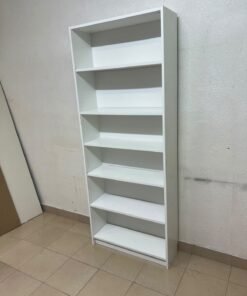 A white bookcase that looks similar to an IKEA BILLY bookcase or other comparable multi-shelf storage units. - Image 7